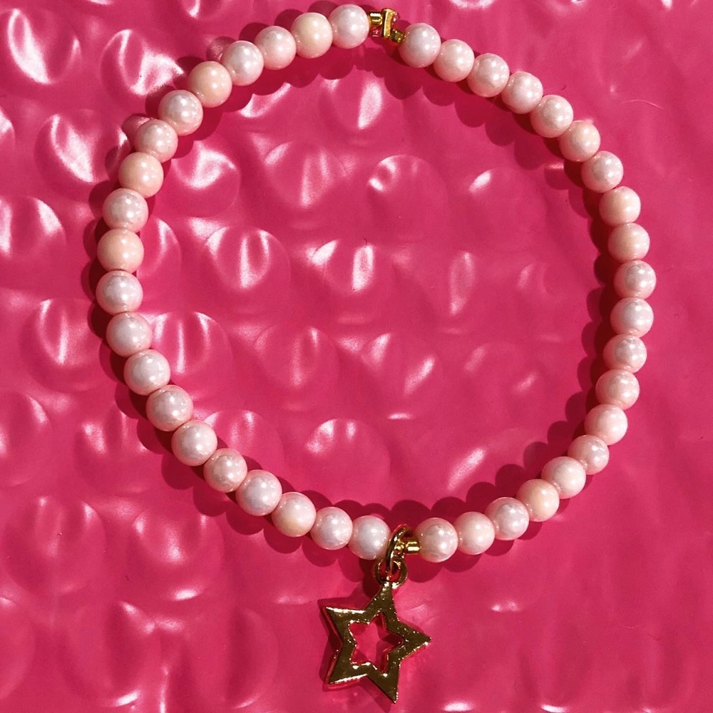 Pink bracelet with gold star charm